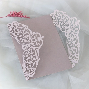 Detail of laser cut hollow invitation cover in glitter pink paper on white mesh