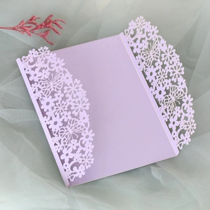 Detail of laser-cut butterfly wedding invitation in lavender pearlescent paper