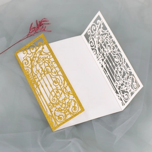 Detailed laser-cut glitter gold wedding invitation featuring elegant scrollwork pattern