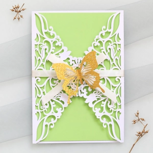 Detailed laser cut butterfly invitation with green inner card and silk ribbon accent