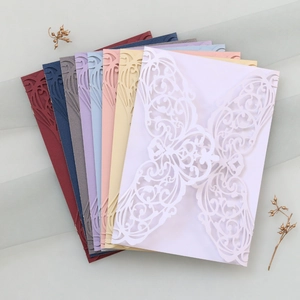 Detailed laser-cut butterfly invitation covers in various elegant glitter paper colors