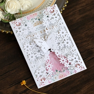 Detail of laser-cut butterfly invitation with elegant floral inner card and white envelope