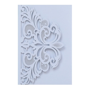 Close-up of intricate laser-cut lace pattern on white wedding invitation card