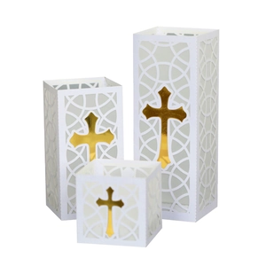 Three white cutout paper lantern bags with gold crosses for religious celebrations