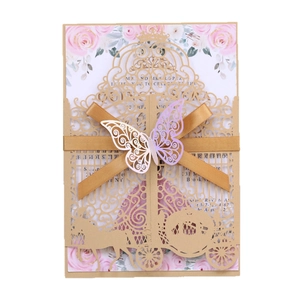 Laser-cut wedding invitation featuring a golden carriage design with a colorful butterfly bow
