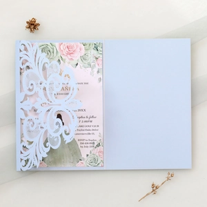 Macro detail of laser cut lace invitation with elegant floral insert and hollow pattern