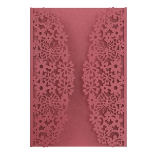 Macro detail of laser-cut burgundy butterfly wedding invitation with pearlescent finish