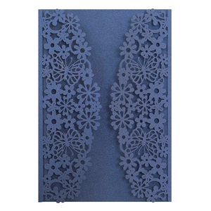 Detail of laser-cut navy blue wedding invitation with butterfly and floral patterns
