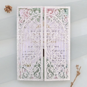 Detail of silver glitter laser-cut butterfly invitation with floral inner card