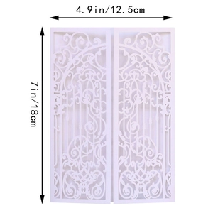 Detail of white laser-cut wedding invitation featuring intricate gate-style floral patterns
