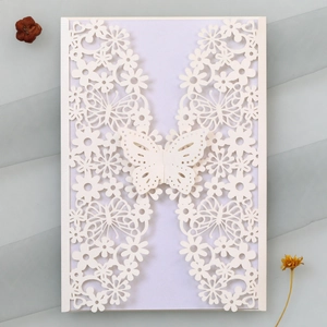 Macro detail of laser-cut butterfly wedding invitation with elegant hollow patterns