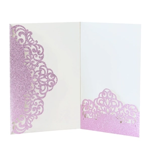Close-up of laser-cut wedding invitation pocket with pink glitter finish and vine pattern