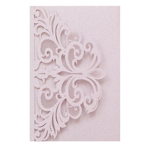 Detailed laser-cut vine patterns on pink glitter cardstock for wedding invitations