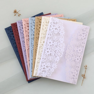 Laser-cut wedding invitations with intricate butterfly and floral patterns in eight colors