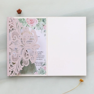 Detailed laser-cut glittery pink invitation with elegant floral inner card layout