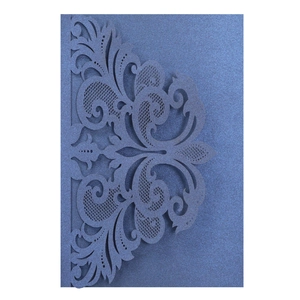 Detail of laser-cut navy blue pearl paper card with intricate floral patterns
