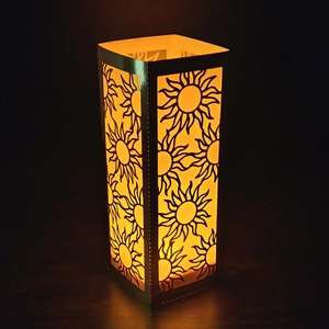 Hollow sun pattern paper lantern with warm light and golden reflective finish