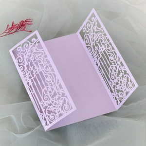 Detail of lilac laser-cut wedding invitation gatefold with intricate floral pattern