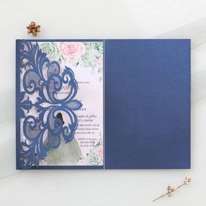 Navy blue laser-cut lace wedding invitation set with floral card on white backdrop
