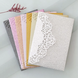 Detailed laser-cut lace wedding invitation covers in various glitter finishes and colors