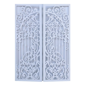 Close-up of laser-cut gatefold wedding invitation with intricate vine patterns