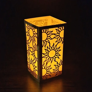 Golden hollow sun pattern paper lantern with warm orange glow for wedding decoration