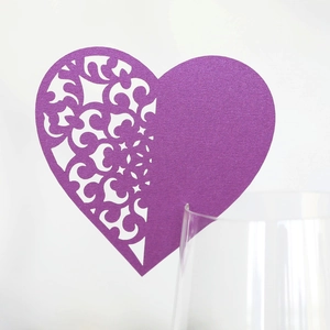 Laser-cut heart-shaped seat card in purple pearl paper for wedding wine glasses