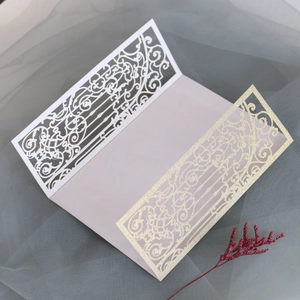 Detailed laser-cut vine patterns on trifold gold glitter and white wedding invitation