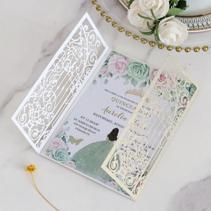 Detail of laser cut butterfly glitter invitation with floral inner card and gold beads