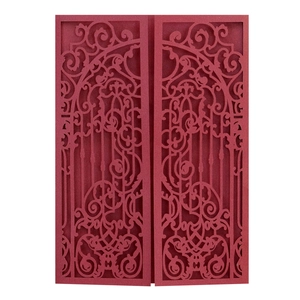 Detail of laser-cut burgundy wedding invitation featuring intricate baroque floral patterns