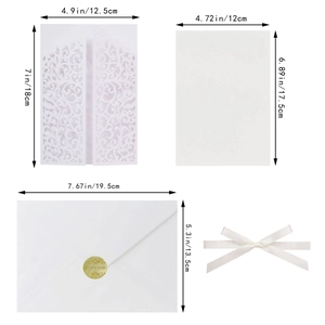 Detailed view of white laser-cut floral invitation set with gold seal and white ribbon
