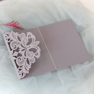 Detailed laser-cut lace floral pattern on elegant lavender wedding invitation card