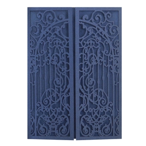 Detailed laser-cut scrollwork and floral patterns on navy blue wedding invitation cover