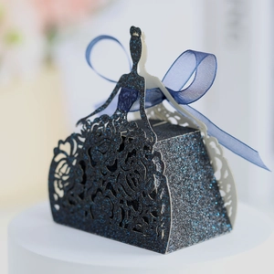 Macro view of blue glitter dress-shaped gift box with laser-cut lace and satin bow