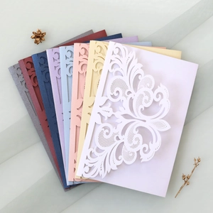 Detail showing multi-color laser-cut lace wedding invitations on elegant mesh fabric