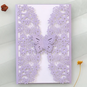 Close-up of purple laser-cut butterfly invitation card with elegant floral hollow details