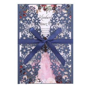 Detailed laser-cut hollow blue wedding invitation with satin bow and floral pattern