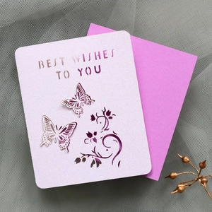 Detail of laser-cut butterfly greeting card with Best Wishes text and purple envelope