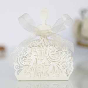 Detail view of laser-cut wedding favor box with floral patterns and ribbon