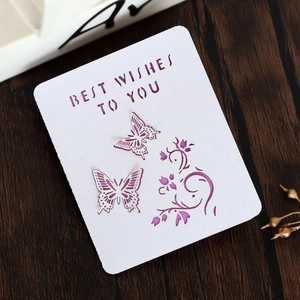 Detail of laser-cut butterfly greeting card with purple paper insert and best wishes text