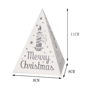 Detail showing white Christmas pyramid paper shade with Merry Christmas cutout and star pattern