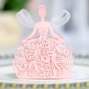 Detail of pink laser-cut princess candy box with intricate floral patterns and white ribbon