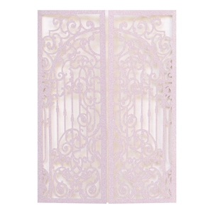 Detail of pink glitter laser-cut invitation card with ornate symmetrical scroll patterns