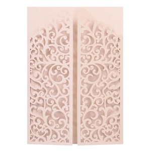 Detail of laser-cut wedding invitation featuring intricate baroque floral patterns in pink