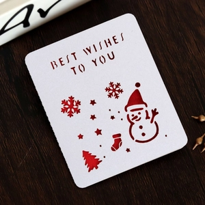 Detailed laser-cut Christmas card with snowman and tree on dark wood texture