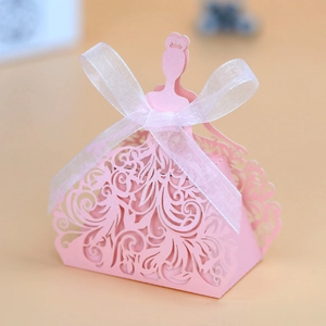 Pink laser-cut princess dress favor box with white organza ribbon and intricate patterns