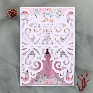 Detail of laser-cut wedding invitation with pink floral inner card and lace pattern