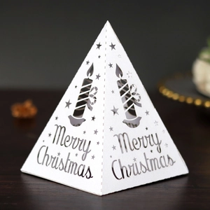 White laser-cut pyramid Christmas candle lantern with Merry Christmas text and stars