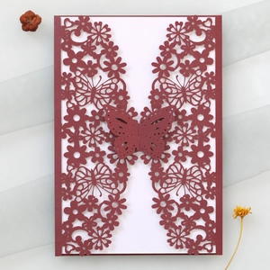 Detailed laser-cut hollow butterfly design on burgundy wedding invitation card cover