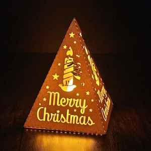 Macro shot of bronze pyramid lantern with warm LED light and Christmas hollow design